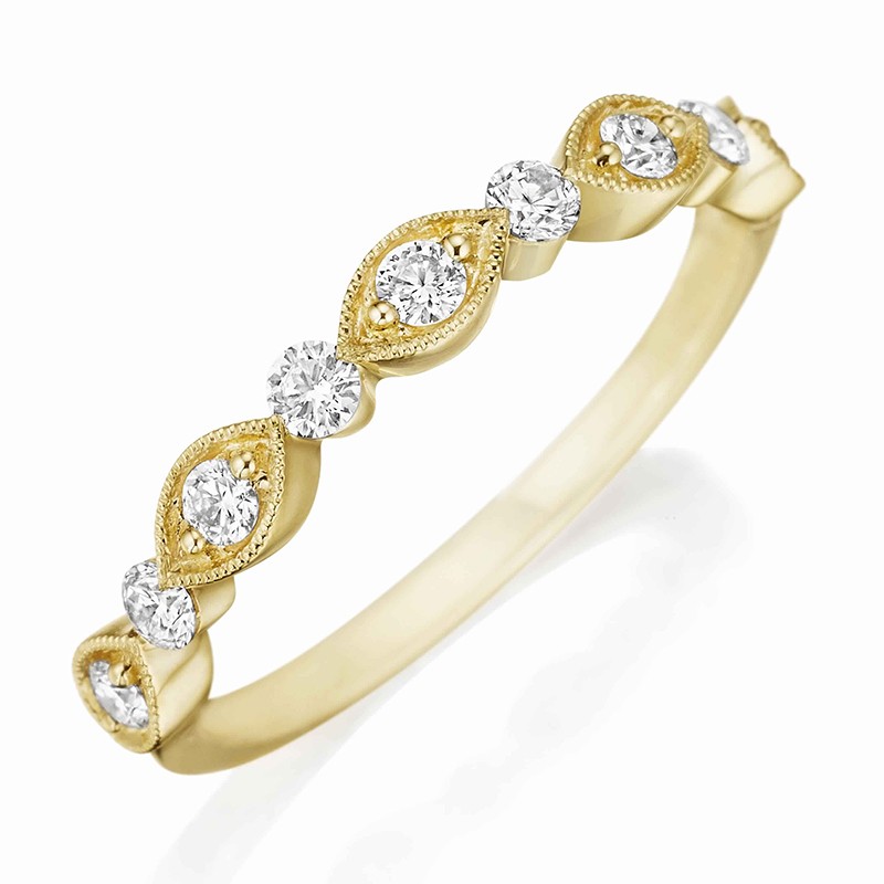 Henri Daussi yellow gold band featuring round brilliant white diamonds with milgrain detail.