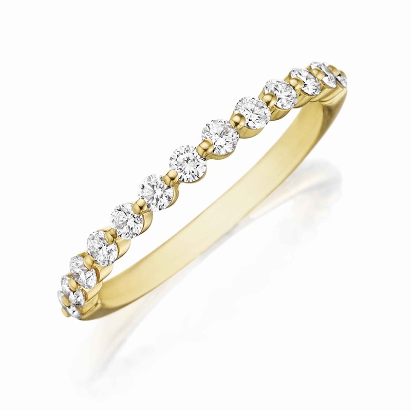 Henri Daussi yellow gold band featuring a shared prong single line of round brilliant white diamonds.